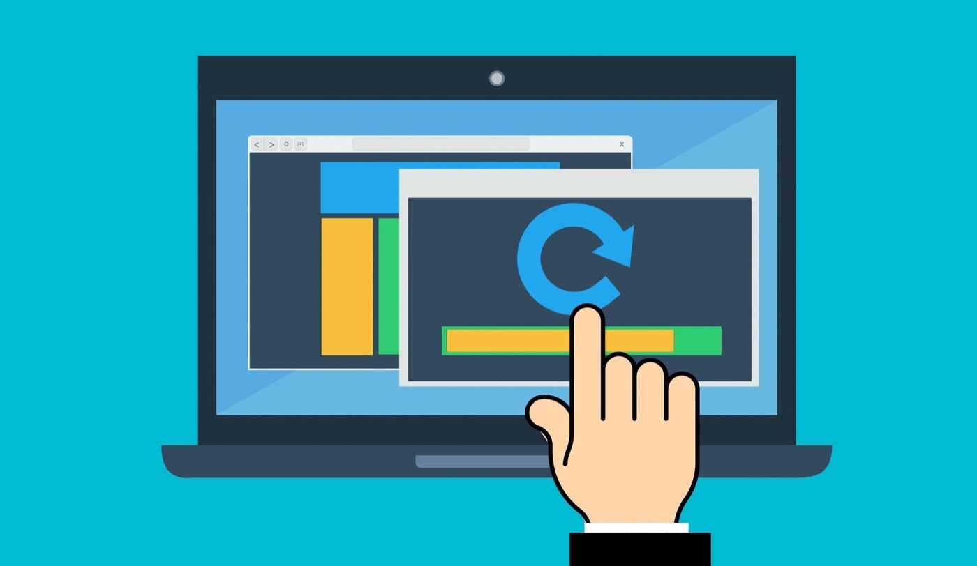 An update symbol and a pointing hand on a laptop screen